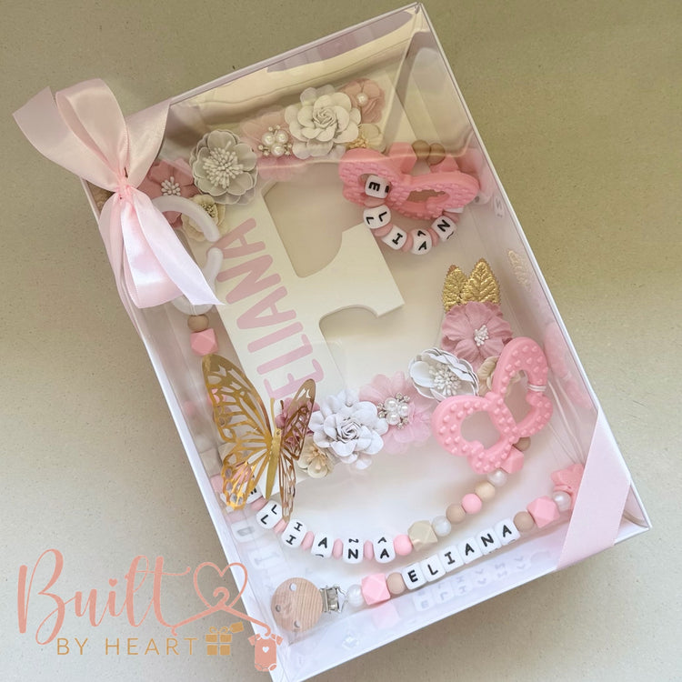 Pink personalised baby accessories gift box with floral details and name beads