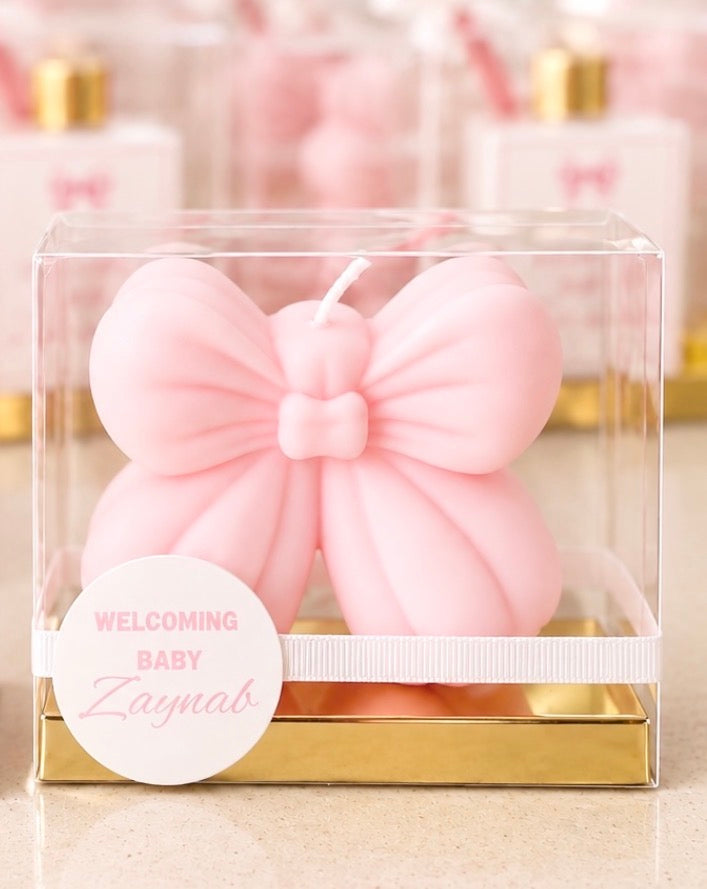 Personalised pink bow candle baby shower favour in clear acrylic box with gold base and welcoming baby tag