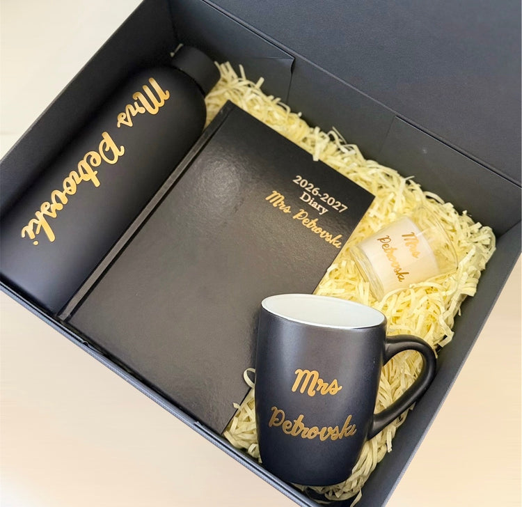 Personalised black and gold teacher gift box with 2026–2027 diary, insulated bottle, mug and glass