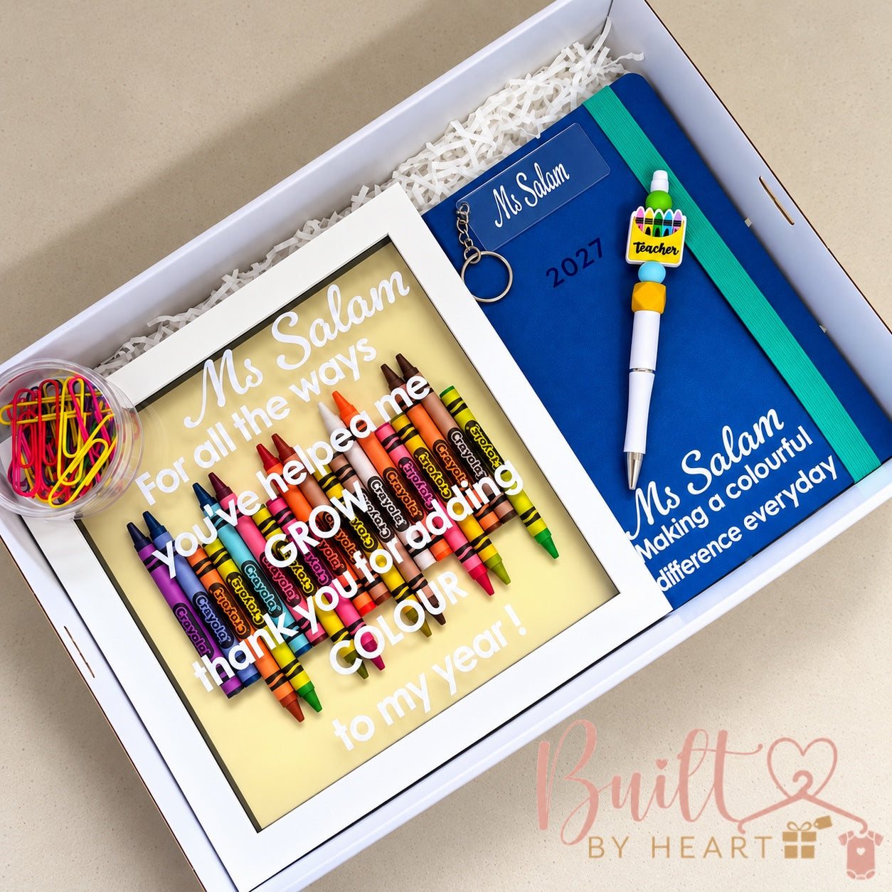Personalised teacher gift box with crayon shadow frame, notebook, pen, keychain and colourful paper clips
